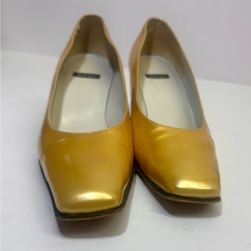 Stuart Weitzman gold leather pumps.